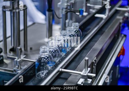 Les bouteilles en plastique clair sur les systèmes de convoyeurs automatisés transfert d'automatisation industrielle pour le package Banque D'Images