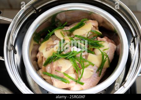 Cuisson du poulet cuit à la vapeur au gingembre avec de l'huile d'oignon de printemps. Banque D'Images