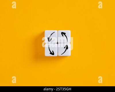 Quatre dés blancs montrent des flèches noires formant un cercle, illustrant un modèle économique d'économie circulaire ou un cercle vicieux répétitif. Banque D'Images