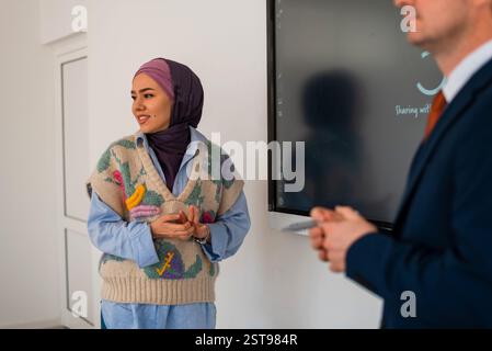Gestionnaire et réunion ou présentation en salle de réunion avec des collègues pour séminaire d'entreprise. Professeur d'université à l'écoute de l'étudiant musulman Banque D'Images