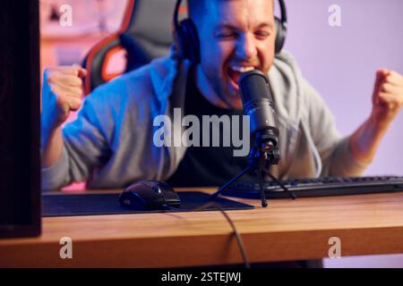 Crier dans le microphone. Homme dans les écouteurs et avec microphone est en direct sur le flux. Banque D'Images