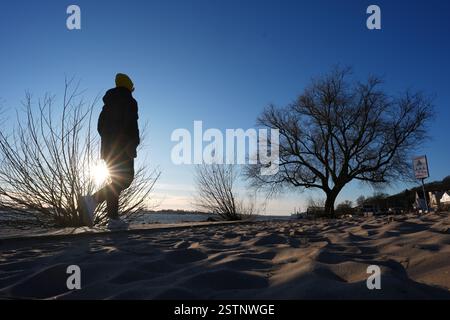 Hambourg, Allemagne. 19 février 2025. Une femme marche le long de la rive de l'Elbe sous le plus beau soleil. Crédit : Marcus Brandt/dpa/Alamy Live News Banque D'Images