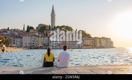 Relaxez-vous au bord des eaux calmes de Rovinj, en Croatie, alors que le soleil se couche sur une charmante architecture côtière Banque D'Images