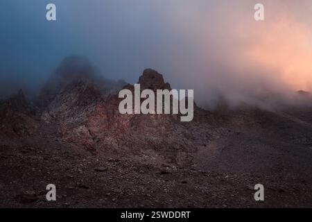 Lumière mystique dans les montagnes brumeuses et sombres. Ciel spectaculaire sur les sommets de montagne. Fond mystique avec des montagnes spectaculaires. Banque D'Images
