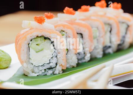 Rouleaux de sushi soigneusement disposés sur une assiette avec des ingrédients frais et des couleurs vives, prêts à être dégustés dans un restaurant japonais Banque D'Images
