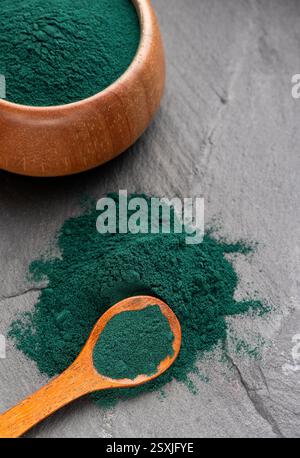 Spiruline poudre complément alimentaire sain - poudre d'algues dans une cuillère et un bol. Banque D'Images