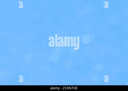 Fond flou magique dans des tons bleus doux avec effet bokeh. Idéal pour le design, les arrière-plans de noël et les projets créatifs. Banque D'Images