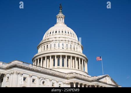 WASHINGTON DC — le côté est du Capitole des États-Unis affiche son architecture néoclassique distinctive avec un dôme central flanqué des ailes de la Chambre et du Sénat. Cette entrée officielle du Capitole fait face au bâtiment de la Cour suprême de l'autre côté de la First Street. Le front est a traditionnellement servi de lieu aux inaugurations présidentielles et dispose de grands escaliers menant à des portiques à colonnes. Banque D'Images