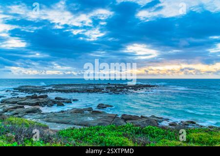Un lever de soleil venteux sur la mer depuis Soldiers Beach à Norah Head, NSW, Australie. Banque D'Images