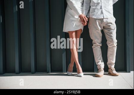 Vue rapprochée. Beau jeune couple est debout ensemble sur fond vert foncé. Banque D'Images