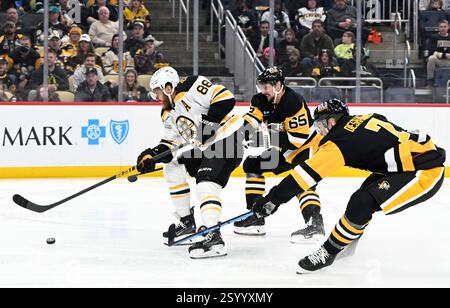 Pittsburgh, États-Unis. 01 mars 2025. David Pastrnak (88 ans), l’aile droite des Bruins de Boston, joue entre Erik Karlsson (65 ans) et Vincent Desharnais (7 ans), défenseur des Penguins de Pittsburgh, lors de la troisième période de la victoire des Bruins de Boston 3-2 au PPG Paints Arena de Pittsburgh, le samedi 1er mars 2025. Photo par Archie Carpenter/UPI. Crédit : UPI/Alamy Live News Banque D'Images