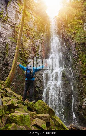 Tourist attraction of Germany - falls of Burgbach Waterfall near Schapbach, Black Forest, Baden-Wurttemberg, Germany. Man hiker Banque D'Images