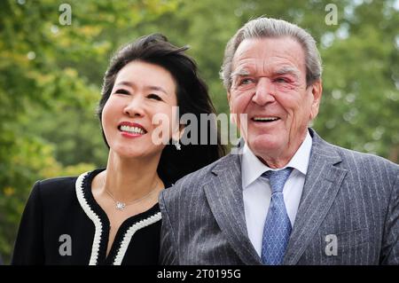 Hambourg, Allemagne. 03 octobre 2023. L'ancien chancelier allemand Gerhard Schröder (à droite) et son épouse So-yeon Schröder-Kim arrivent devant l'église principale de St. Michaelis (Michel) pour la célébration centrale de la Journée de l'unité allemande. Dans le cadre de sa présidence du Bundesrat, Hambourg accueille les célébrations centrales de la Journée de l'unité allemande sous la devise «Ouvrir les horizons». Crédit : Christian Charisius/dpa/Alamy Live News Banque D'Images