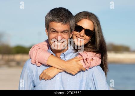 Portrait de beau couple heureux mature posant à l'extérieur près de la mer Banque D'Images