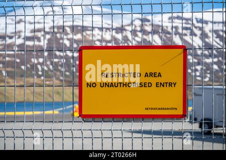 Panneau jaune zone réglementée interdite d'entrée non autorisée au port de Seydisfjordur, Islande Banque D'Images