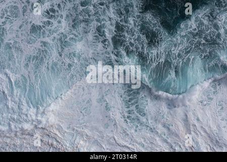 Vagues parfaites pour le surf. Les vagues éclaboussent dans l'eau turquoise au large de la côte. Banque D'Images