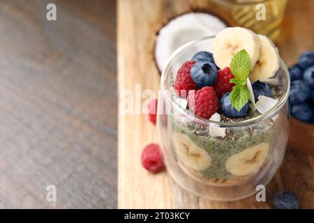 Savoureux flocons d'avoine avec du pudding chia matcha et des fruits sur une table en bois, espace pour le texte. Petit déjeuner sain Banque D'Images