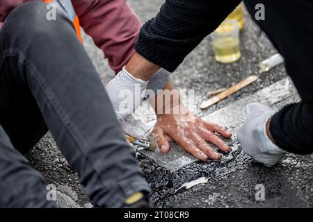 Berlin, Allemagne. 05 octobre 2023. Les membres de la dernière génération sont restés dans la rue du 17 juin devant la porte de Brandebourg. Les militants pour le climat de la dernière génération avaient de nouveau mis en place des barrages routiers à plusieurs endroits à Berlin jeudi matin, y compris à la porte de Brandebourg. Crédit : Fabian Sommer/dpa/Alamy Live News Banque D'Images