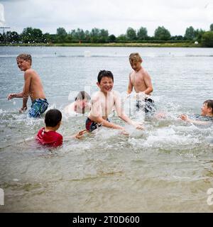 Les élèves du secondaire éclaboussent dans l'eau, dans le lac, sur un parcours allant vers l'extérieur faisant des activités de plein air Banque D'Images