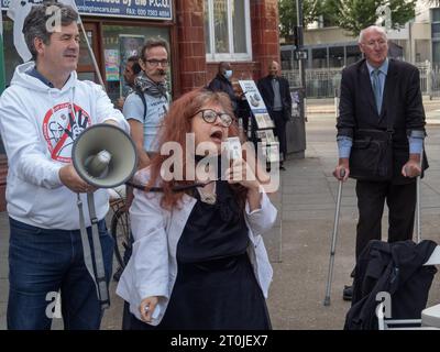 Londres, Royaume-Uni. 7 octobre 2023. Chantant une chanson critique de Starmer. Un jour avant la conférence travailliste, les gens se rencontrent dans la circonscription de Keir Starmer pour avertir tout le monde à quel point un gouvernement dirigé par Starmer serait dangereux. Parmi les participants figuraient de nombreux anciens membres du Parti travailliste qui disent qu'il n'a pas de principes et énumèrent près de 30 promesses sur lesquelles il a jusqu'à présent renié, y compris les emplois verts, l'externalisation du NHS, la réforme des Lords, les repas scolaires gratuits, droits des travailleurs, contrats pétroliers, relations publiques, garde d'enfants. Paula Peters de DPAC tient une affiche.. Peter Marshall/Alamy Live News Banque D'Images