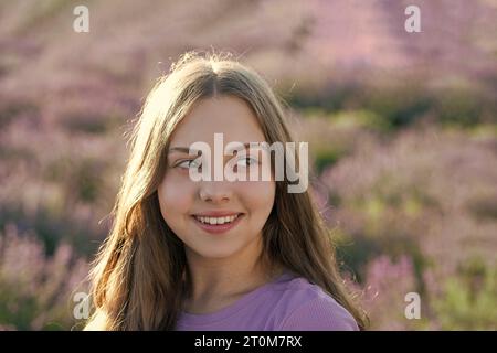 Fille appréciant le champ de lavande en fleurs. fille joyeuse dans le champ de fleurs de lavande. adolescente tenant un bouquet de fleurs de lavande. Portrait d'un Banque D'Images