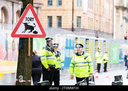 Conférence du Parti conservateur un signe de blague parodie avertissant de conneries Tory devant le Midland Hotel Manchester, à proximité des policiers de GMP en octobre 2023 Banque D'Images