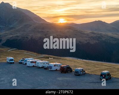 This aerial drone photo shows a group of campers on top of a mountain. The campers are wild camping and enjoying the view in Andorra. Banque D'Images