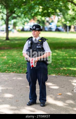 Officier de police Métropolitaine sur place à la bombe Parsons Green, attendant avec la bande d'incident de la police au cordon. Poches à pantalon baggy Banque D'Images