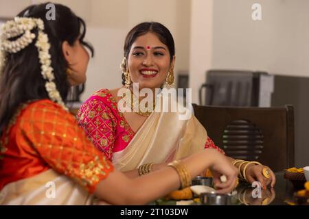 Des femmes heureuses ayant Onam Sadhya ensemble à la maison Banque D'Images