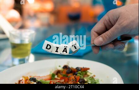 Le mot allemand 'diaett' (régime) sur une cuillère dans un restaurant. Symbole pour avoir trop de sucre dans la plupart des plats. Banque D'Images