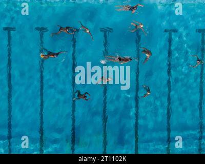 Vue aérienne drone de personnes en compétition dans le water-polo dans la piscine d'eau turquoise Banque D'Images