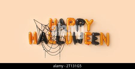 Texte HAPPY HALLOWEEN fait de ballons sur fond beige Banque D'Images