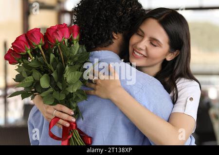 Rencontres internationales. Heureux couple serrant dans le restaurant Banque D'Images