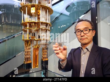 Kawasaki, Japon. 11 octobre 2023. Le géant informatique japonais Fujitsu, chef de laboratoire quantique felllow, Shintaro Sato, présente le modèle réduit du nouvel ordinateur quantique supraconducteur et sa puce de 64 qubits au laboratoire Fujitsu de Kawasaki, dans la banlieue de Tokyo, le mercredi 11 octobre 2023. Fujitsu a annoncé sa stratégie de recherche et développement au laboratoire. (Photo de Yoshio Tsunoda/AFLO) Banque D'Images