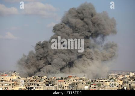 Rafah, Gaza. 11 octobre 2023. De la fumée monte au-dessus des bâtiments, dans le sud de la bande de Gaza, suite à une frappe israélienne, le mercredi 11 octobre 2023. Les responsables de Gaza ont signalé que plus de 1055 personnes avaient été tuées alors qu’Israël pilonnait le territoire avec des frappes aériennes. Photo par Ismael Mohamad/UPI crédit : UPI/Alamy Live News Banque D'Images