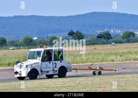 Flugzeugschlepper beim Tag der Bundeswehr Ein kleiner Flugzeugschlepper fährt über die Landebahn des Militärflugplatzes in Bückeburg. Im hintergrund sind Schulungshubschrauber EC 135 zu sehen. Spotterday zum Tag der Bundeswehr TdBW in Bückeburg 2023 an diesem Tag wurden interessierte Fotografen zum sogenannten Spotterday eingeladen. Dieser fand in Vorbereitung zum jährlich ausgerichteten Tag der Bundeswehr am Internationalen Hubschrauber Ausbildungszentrum statt. Bückeburg Niedersachsen Allemagne *** tracteur d'avion à la Journée des forces armées allemandes Un petit tracteur d'avion roule au-dessus du Banque D'Images