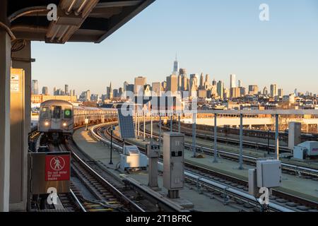 Vue de l'heure d'or de la ville de New York et un train G approchant à Sunrise sur la portion de chemin de fer surélevée de la ligne G à Smith Street. Banque D'Images