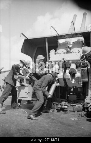 Une visite d'un navire, l'Angleterre, 1940 Royal Marines coquillages de charge dans l'une des 4 pouce de canon anti-aérien lits 1 fixations, à bord de ce navire anti-aérienne, quelque part en Angleterre, 1940 Banque D'Images