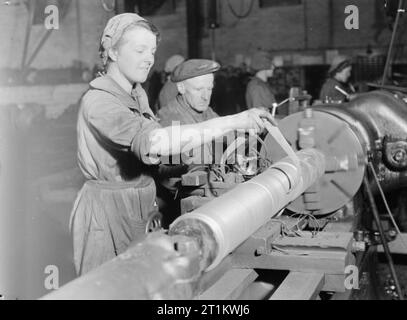 Les travaux de la guerre- La vie dans une usine de Shell, England, UK, 1942 50 Mme McFarland de Barnsley Road, Wombwell voyages 3 heures par jour à travailler sur un tour de la barre de coupe, des bars pour faire des obus sur cette usine, quelque part dans le Yorkshire. Banque D'Images