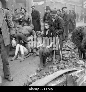 L'Armée britannique au nord-ouest de l'Europe 1944-1945, les travailleurs esclaves Russes libérés d'être secouru d'une cave après qu'elle a été incendiée par un policier allemand, Osnabruck, 7 avril 1945. Banque D'Images