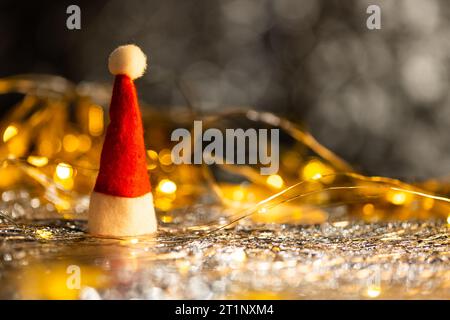 Décorations de noël en or et chapeau de père noël avec espace de copie sur fond noir Banque D'Images