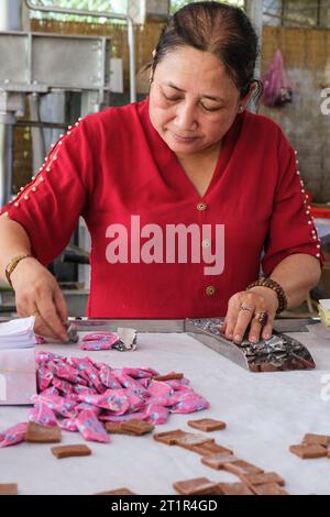 Fleuve Mékong, Vietnam. Femme enveloppant Candy dans Coconut Candy Factory. Banque D'Images