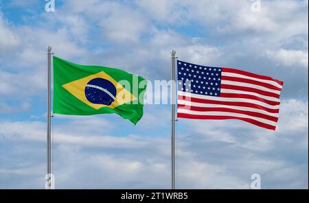 Drapeaux des États-Unis et du Brésil agitant ensemble dans le vent sur le ciel nuageux bleu, concept de relation de deux pays Banque D'Images