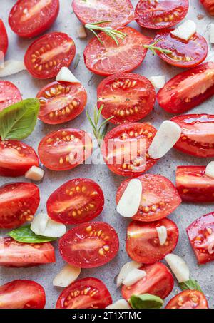 Tranches de tomates fraîches aux herbes. Tomates séchées maison sur plaque de cuisson Banque D'Images