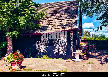 Fragment de peinture florale sur les dépendances rurales. Banque D'Images