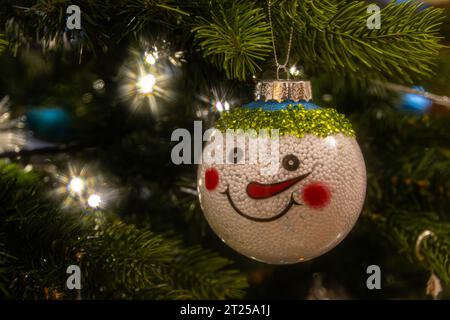Gros plan d'une décoration de Noël de bonhomme de neige accrochée à l'arbre de Noël Banque D'Images