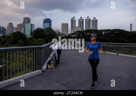 Bangkok, Thaïlande. 17 octobre 2023. Un coureur fait son chemin à travers le parc forestier Benchakitti à Bangkok, Thaïlande, le mardi 17 octobre 2023. (Image de crédit : © Andre Malerba/ZUMA Press Wire) USAGE ÉDITORIAL SEULEMENT! Non destiné à UN USAGE commercial ! Banque D'Images