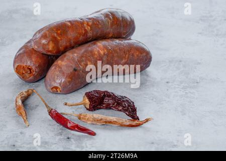 Sur la table en béton, il y a une saucisse Nduja en forme d'arbre avec un petit piment séché sur le dessus, vu d'une vue de dessus. Banque D'Images