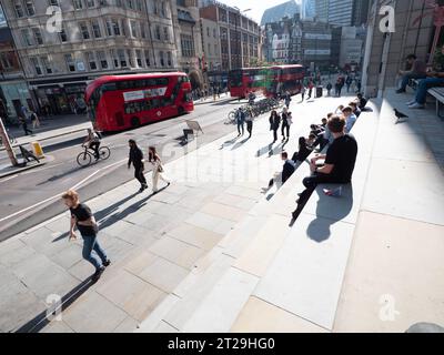 Bishopsgate, au centre de Londres, le 10 octobre 2023, alors que les employés de bureau et les navetteurs profitent du soleil d'automne exceptionnellement chaud. Des piétons et une ligne de bus à impériale rouges circulent sur l'artère principale, qui sert d'artère principale entre la gare de Liverpool Street et le quartier financier de la Cité de Londres Banque D'Images