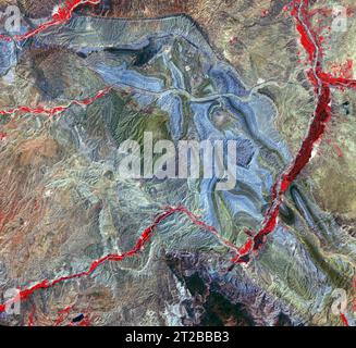 . Folded Rocks, Iran. En Iran, près de la rive sud-ouest de la mer Caspienne, les roches sédimentaires pliées font partie de la ceinture montagneuse du Grand Caucase. Dans l'infrarouge de fausse couleur, les roches de couleur bleue sont des sédiments blancs, les roches au ton verdâtre sont des lits rouges. Le canal de la rivière végétalisée est rouge vif. La ligne noire qui traverse l'image d'est en ouest est l'Iran Highway 2 qui commence à Téhéran et se termine à Tabriz. L'image a été acquise le 22 juin 2020, couvre une superficie de 37,6 par 40,9 km, et est située à 37,1 degrés nord, 47,6 degrés est. Banque D'Images